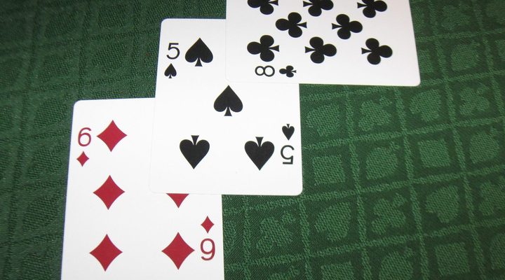 Blackjack hands dealt face up on green felt