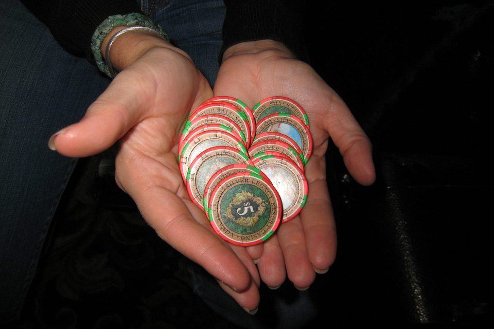 A hand holding a stack of casino chips