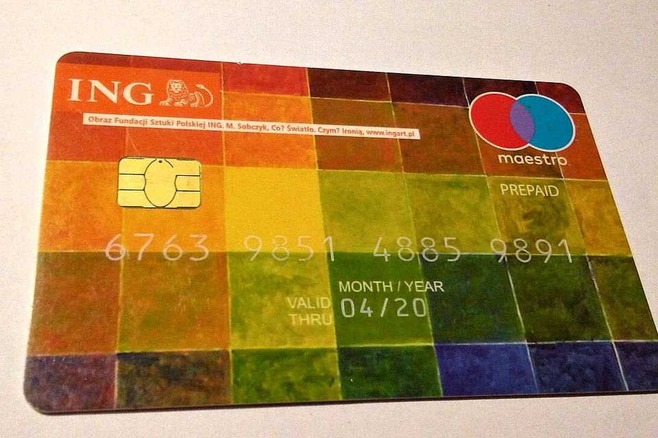 A prepaid payment card lying on a flat surface, chip and printed card face visible