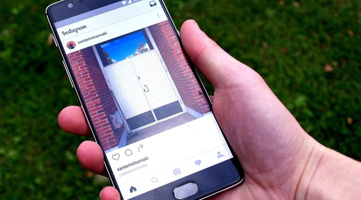 Hand holding a smartphone with a web page open
